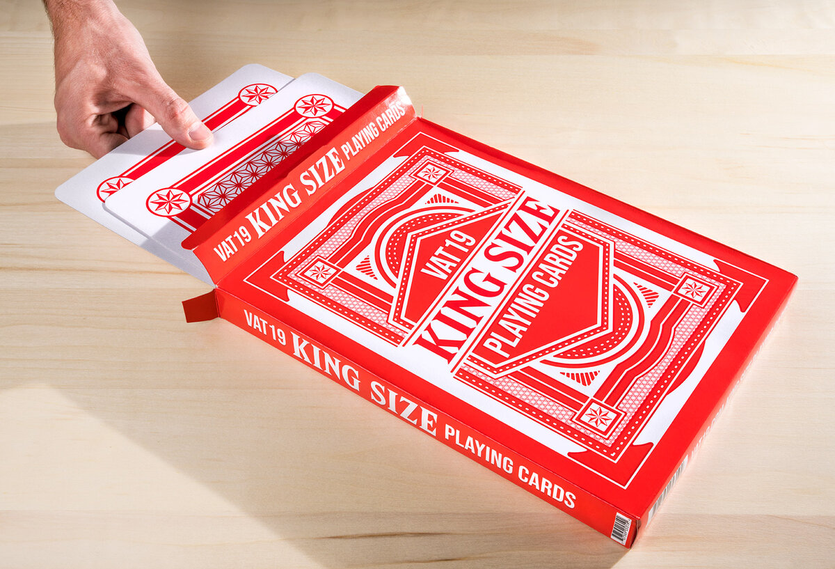 Hands pulling King Size Playing Cards from its cool box.
