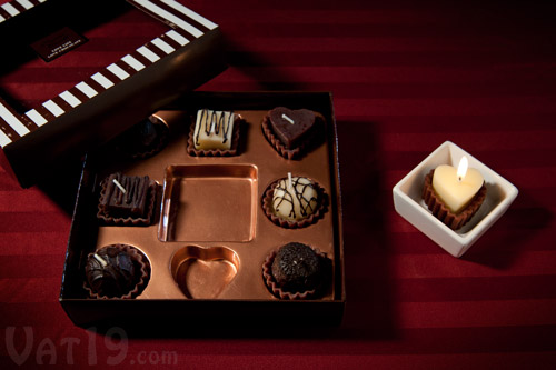 Box of Chocolates Candles on a table.