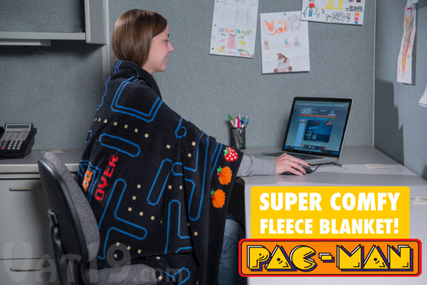 Woman enjoying a cozy web browsing experience with her plush Pac-Man Fleece Blanket.